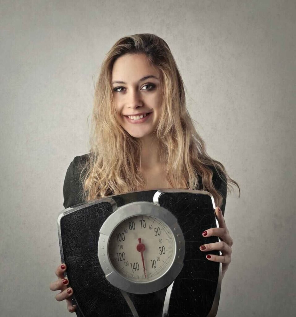 Women Holding weighing machine